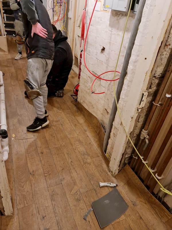 Team laying flooring in corridor