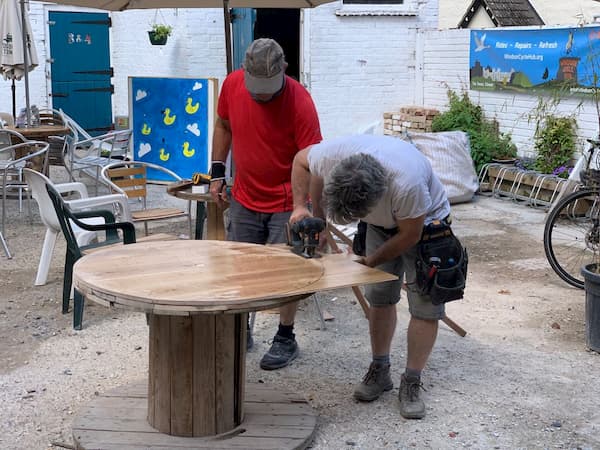John and Thomas cutting a new table top