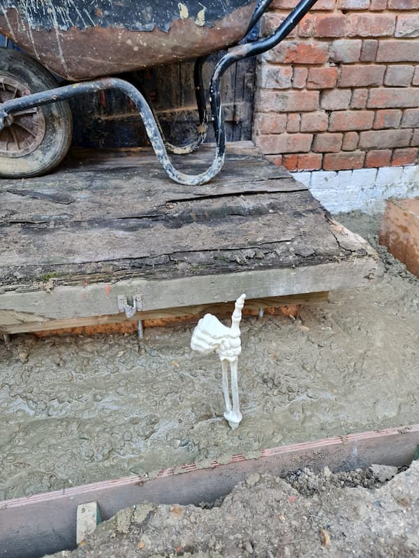 Warrior humour - hand of a skelton sticking out of the concrete with thumb up