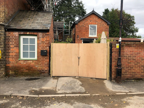 Repaired gate post and repointed wall