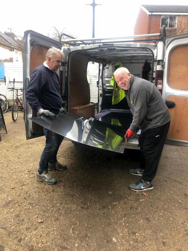 Help has arrived, taking the sheet out of the van