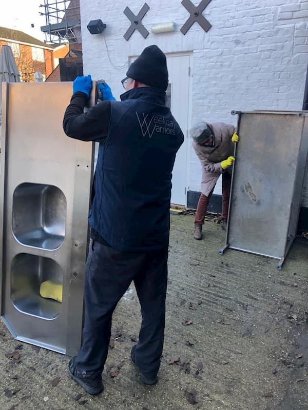 John cleaning the sink ready for reinstallation in The Kitchen