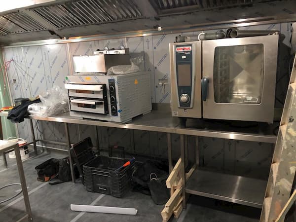 The equipment has been installed under the new cooker hood, the stainless steel backing still covered