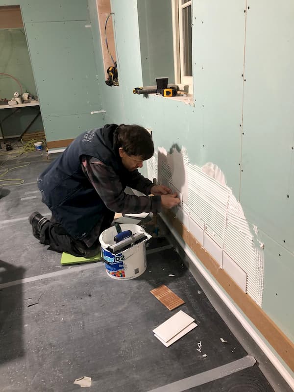 Ian starting on the tiling below the new windows - very clean white tiles are being used!