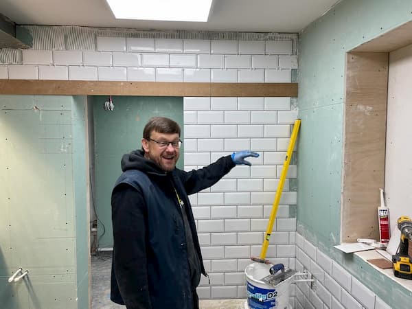 Ian showing the tiled wall to The Coldstore