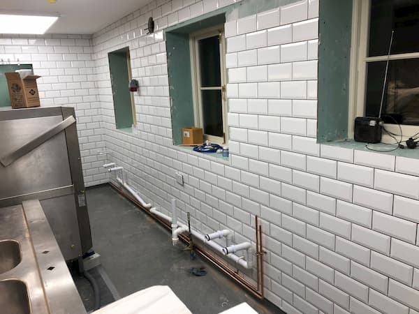 Kitchen wall containing the windows is fully tiled but needs grouting