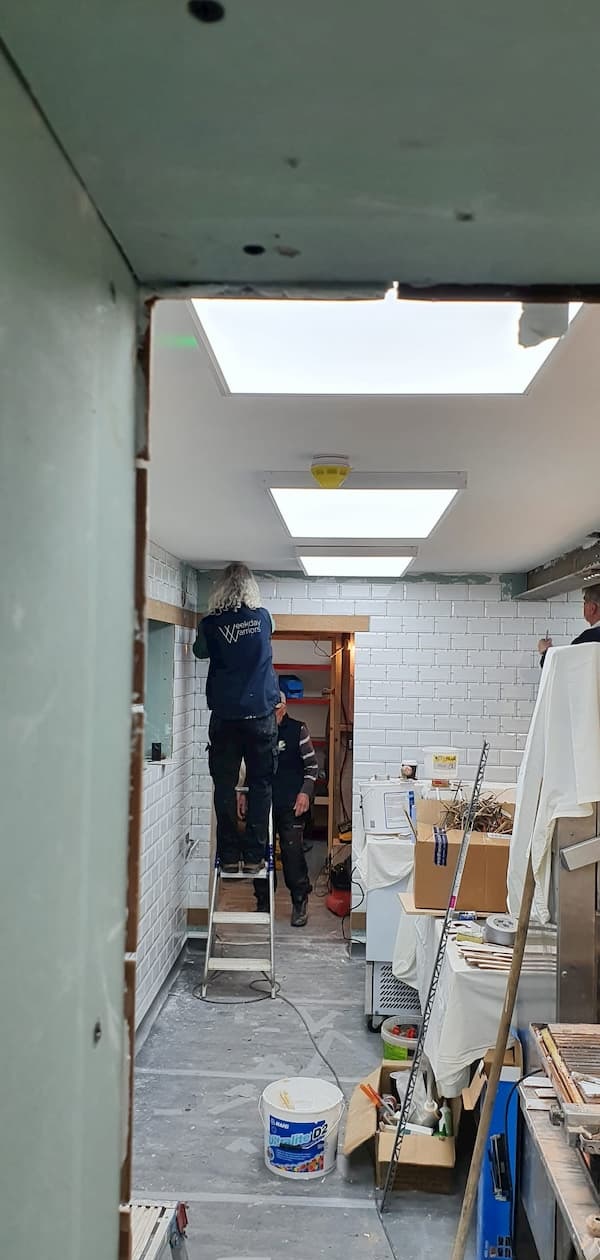 Finishing the tiling over the door into The Kitchen