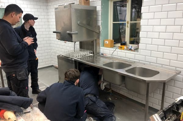 Working on the plumbing underneath the sink