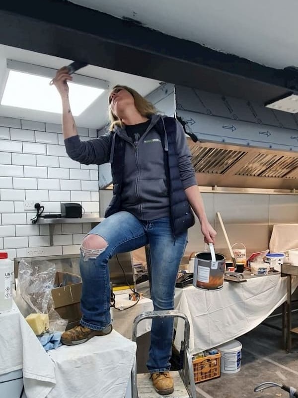 Lexie painting the steel support beam