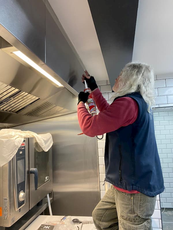 Tony sealing the cooker hood