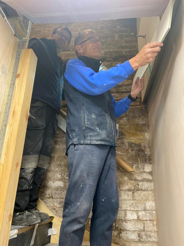 Ian and Trevor fitting the final touches to the stairwell to The School Room