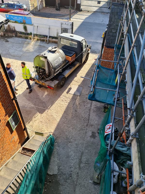 Photo from above showing The Courtyard with the tar machine parked up