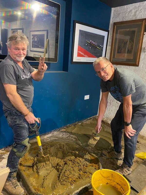 The lads mixing up concrete in The Coach House