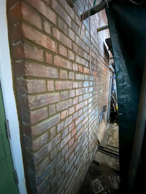 Pointing work down at the cellar entrance.