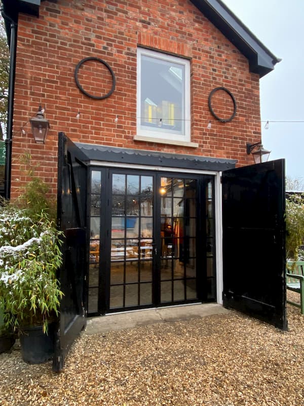 The front of The Coach House in the daylight; all the black trim looks great.