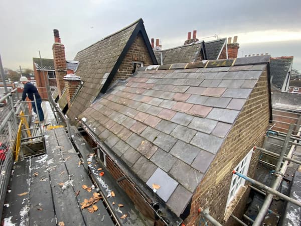 Warren up on the roof disassembling the scaffolding.