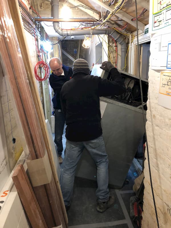 Man handling equipment through The Kitchen door
