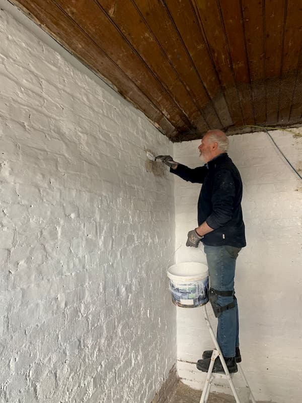 Keith painting the internal wall of stable 5