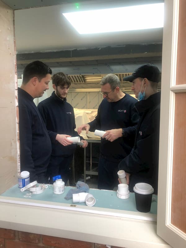 Discussing cutting of the plastic pipework