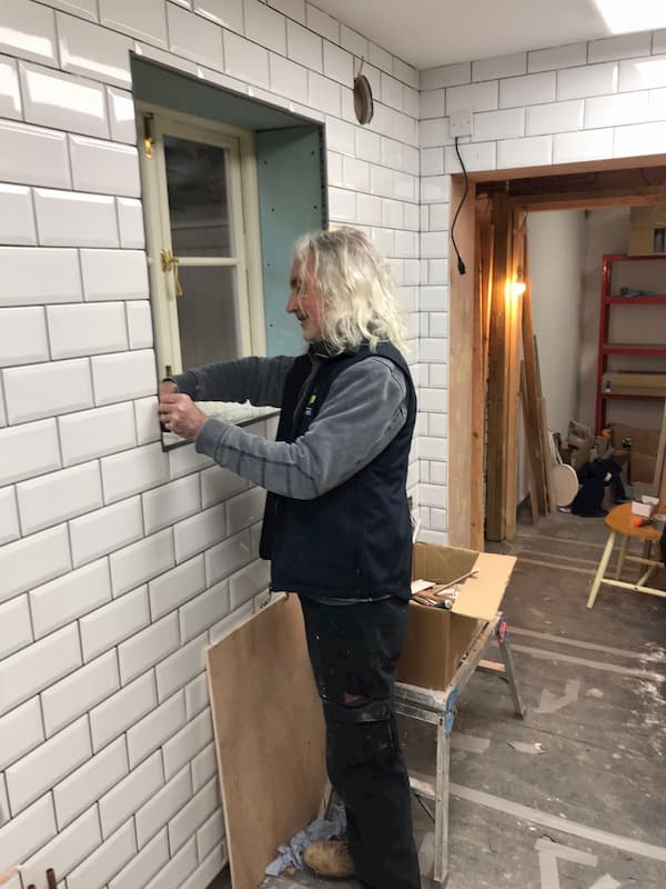 Tony doing the fiddly tiling round the windows