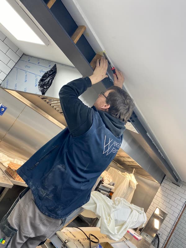 Ian puting battens in the steelwork in The Kitchen