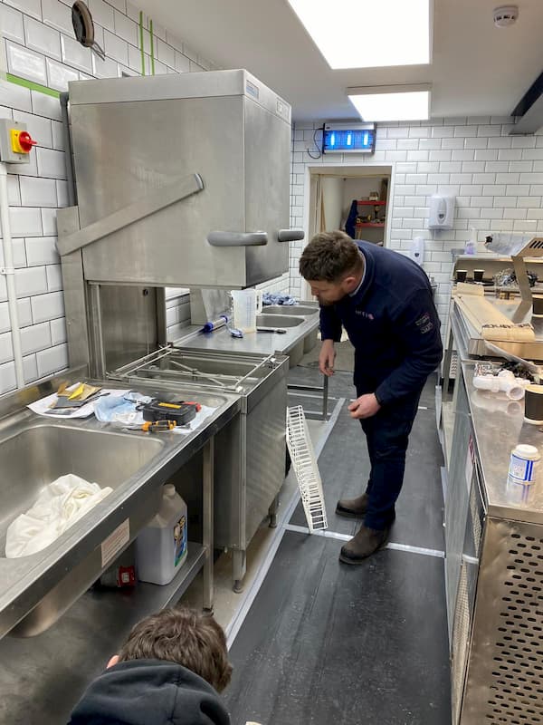 McFarlane Telfer connecting up some of the kitchen equipment