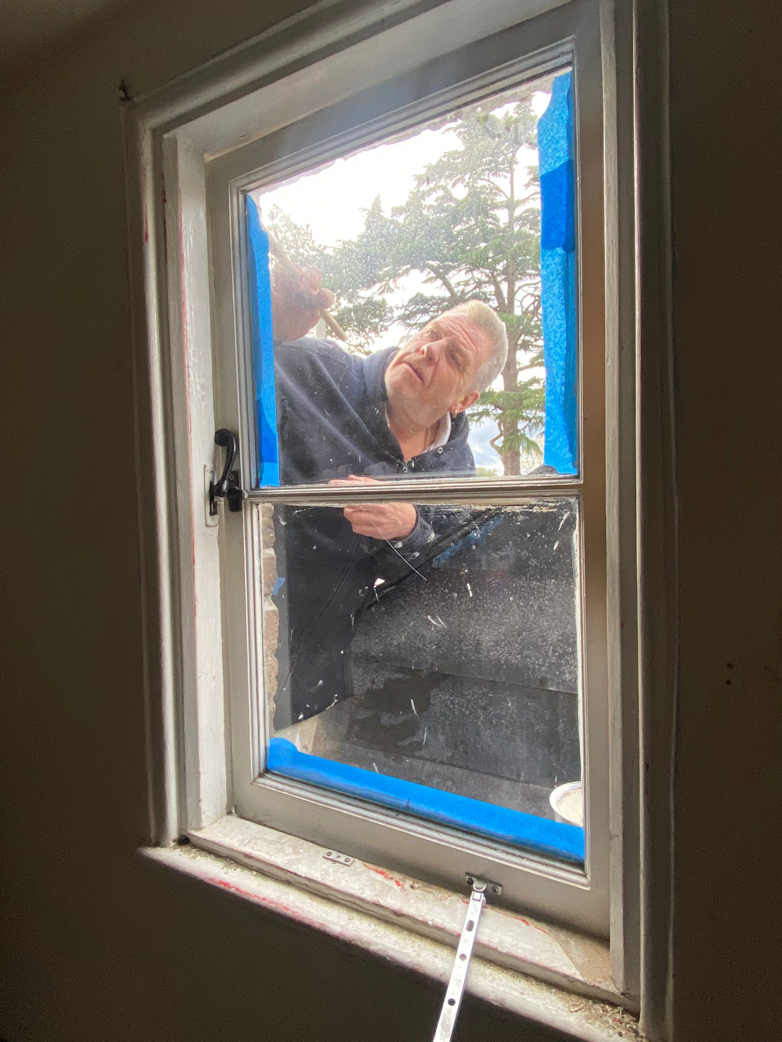 Painting the outside of the window, picture taken from inside.