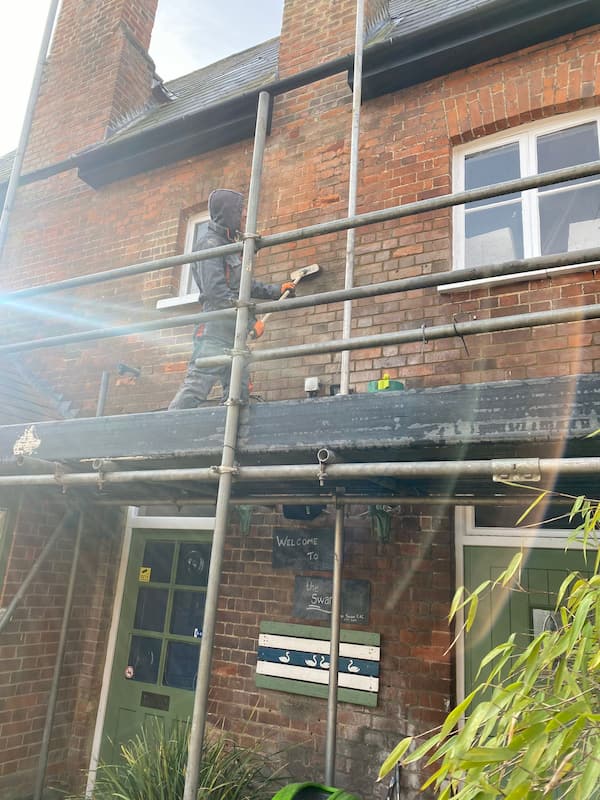 Washing the first floor walls to remove the built up grime.