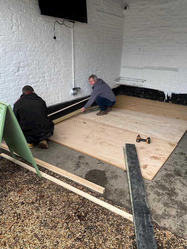 Carpenters measuring out the bar floor insitu.