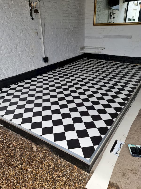 The new laminated floor all laid in the covered area, waiting for the portable bar and sink to be added.