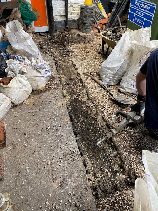 Starting the foundation trench for the wall to hide the bins.