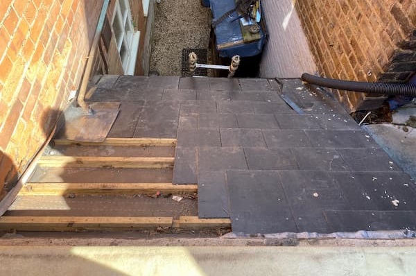 Roof at the back door with some slates removed.