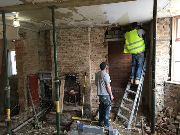Guys working on replacing brickwork