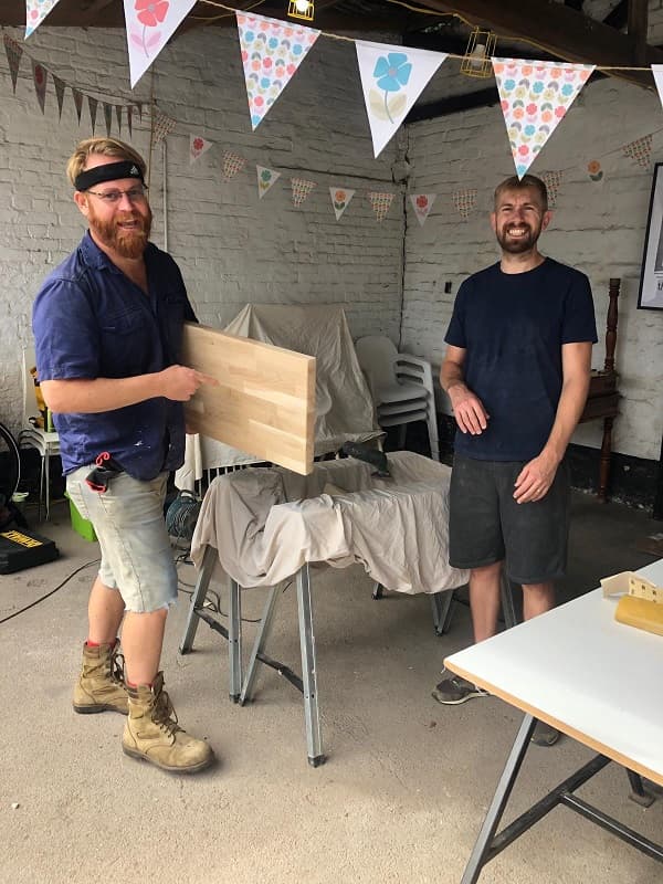 Guys preparing the wood for adding legs