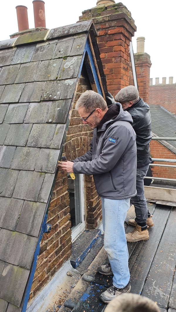 Guys getting stuck into repairing the gable end