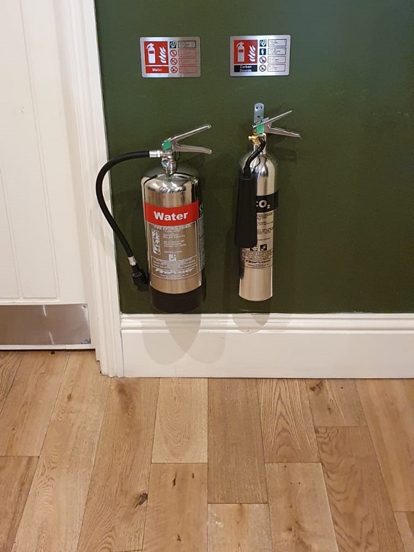 New fire extinguishers outside the gents toilet