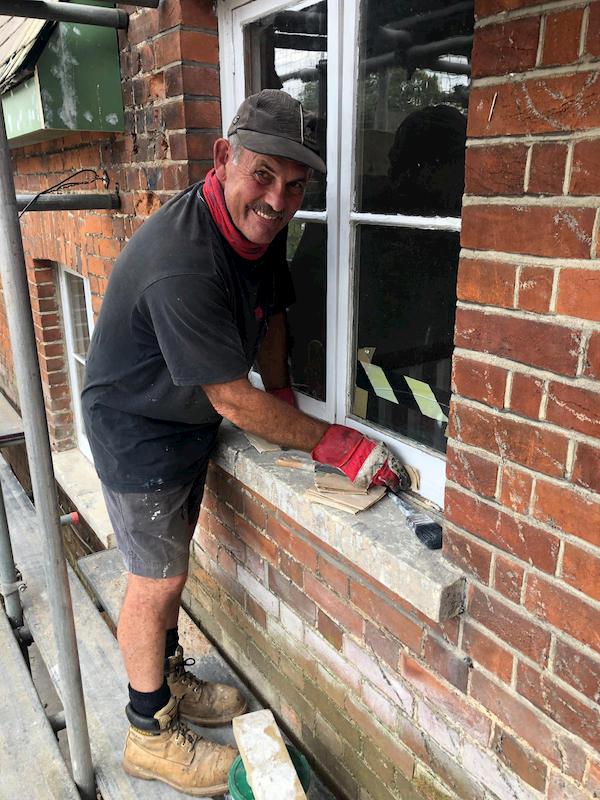 Scraping one of the window frames of the main pub