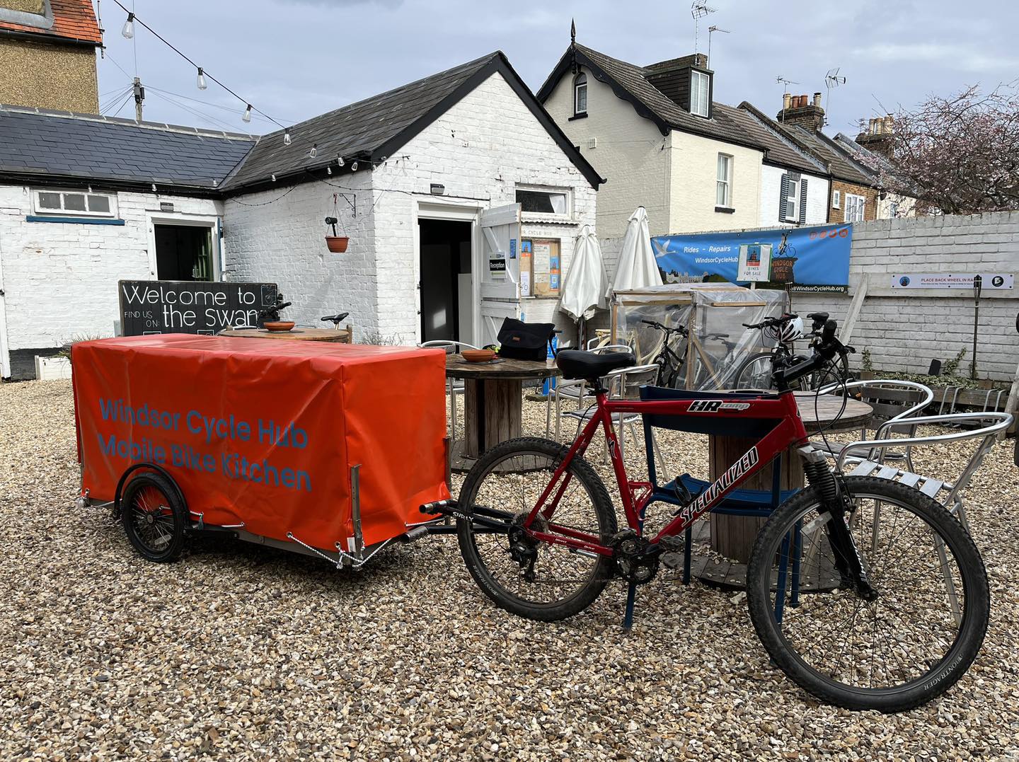 The new mobile bike kitchen, a bright red trailer full of equipment, attached to a bike, of course.