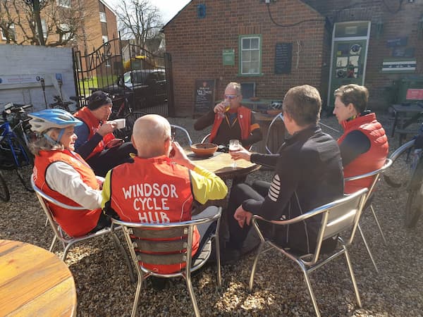 Cyclist enjoy a small beverage after the weekly ride.